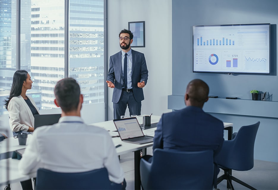 Business professional sharing AI simplified data in a meeting